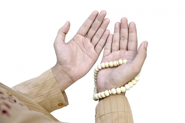 Muslim man praying with prayer beads