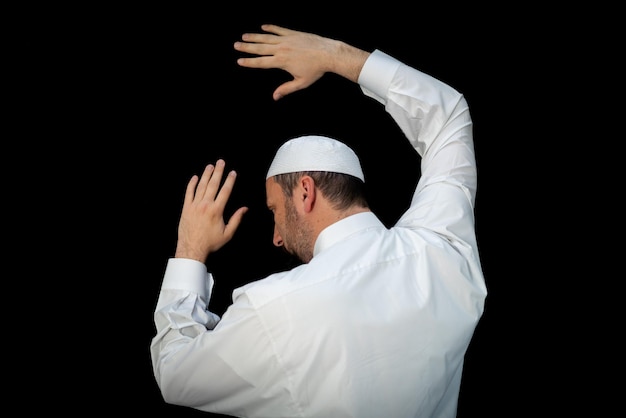 Muslim man standing and praying in the front of kaaba in mecca ksa