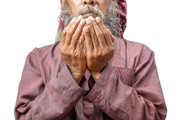 Muslim man with a beard wearing keffiyeh with agal in praying while raised hands