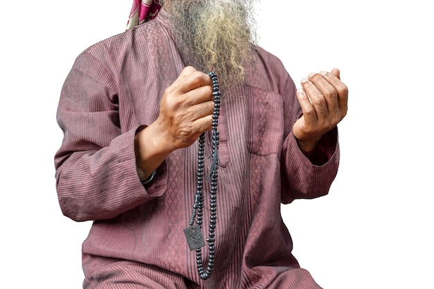 Muslim man with a beard wearing keffiyeh with agal praying with prayer beads on his hands