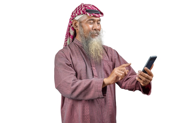 Muslim man with a beard wearing keffiyeh with agal using mobile phone