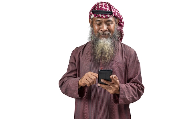 Muslim man with a beard wearing keffiyeh with agal using mobile phone