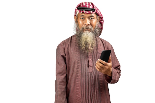 Muslim man with a beard wearing keffiyeh with agal using mobile phone