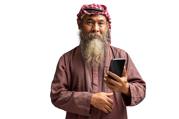 Muslim man with a beard wearing keffiyeh with agal using mobile phone