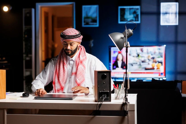 Muslim man with his laptop on table