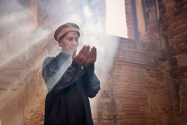 Muslim men praying at an old mosque in Ayutthaya, Thailand