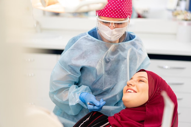 Muslim middle eastern girl inside dentist office high quality photo