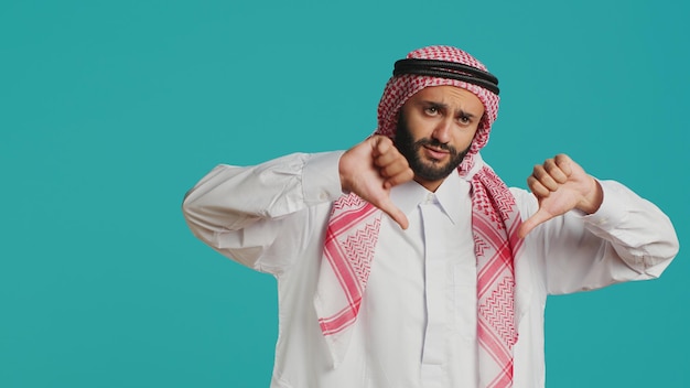 Muslim person gives thumbs down