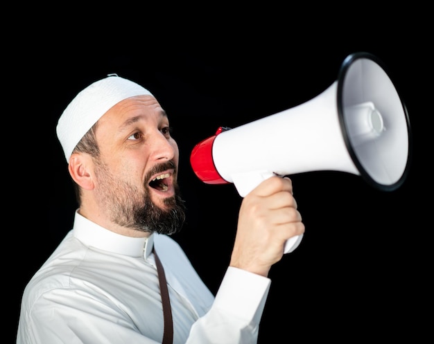 Muslim pilgrim in white traditional clothes saying message on megaphone high quality photo