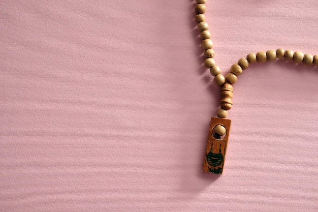 muslim prayer beads against pink color background