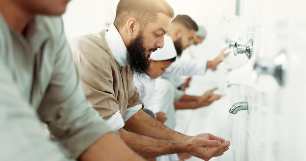 Photo muslim religion ritual and men washing before prayer in bathroom for purity and cleaning islamic worship and faith of group of people with wudu together at a mosque or temple for holy practice