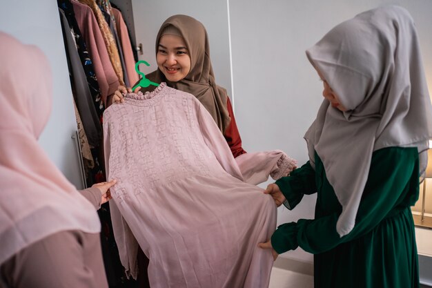 Muslim woman friend picking up some dress