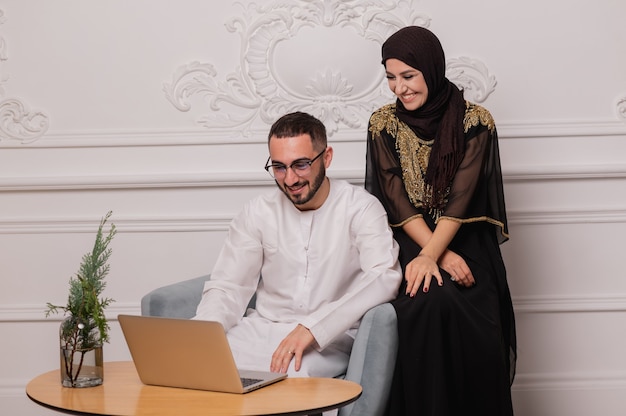 Muslim woman and man. Close up Portrait of a young arab girl and man in traditional dress.