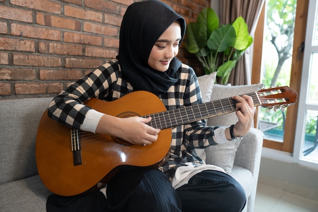 Muslim woman playing guitar