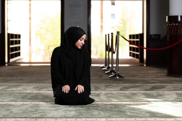 Muslim Woman Praying at the Mosque