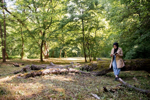 Muslim woman reading a book in the park during her free time