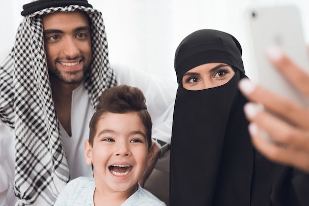 Muslims sit at home and take a selfie on the phone.