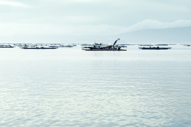 Mussel boat working near mussel beds in sea