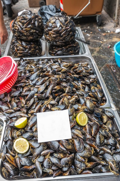 Mussels in the net at one of the fish stall that you can find at the fish market in Catania. Italy.