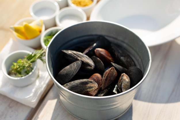 Mussels shells in bucket on wooden background