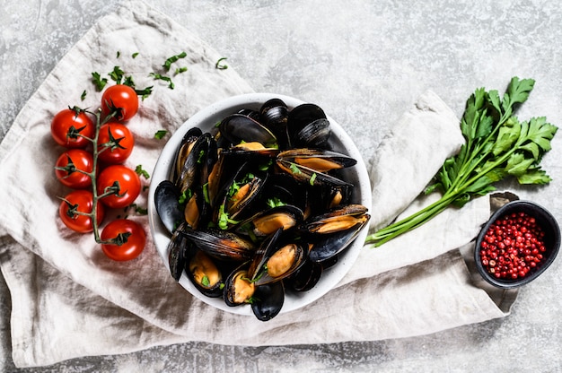 Mussels with herbs and sauce in bowl.  Graysurface