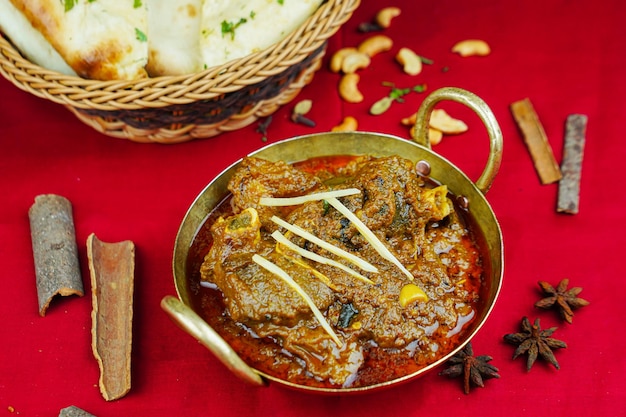 Mutton bhuna korma rogan goshat with bread served in karahi isolated on table top view of indian pakistani and punjabi spicy food