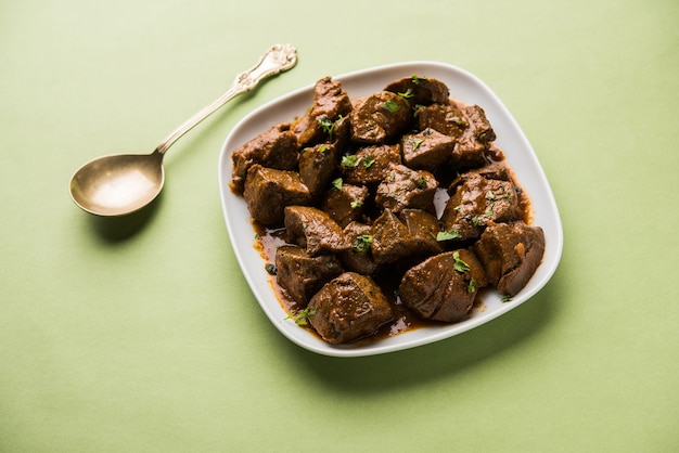 Mutton Liver fry or Kaleji masala, popular Non vegetarian recipe from India and Pakistan. served dry or with curry in a bowl, karahi or plate