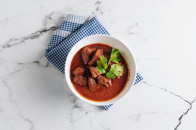 Mutton Rogan Josh mutten qorma mutten curry mutton karahi in a dish isolated on napkin side view