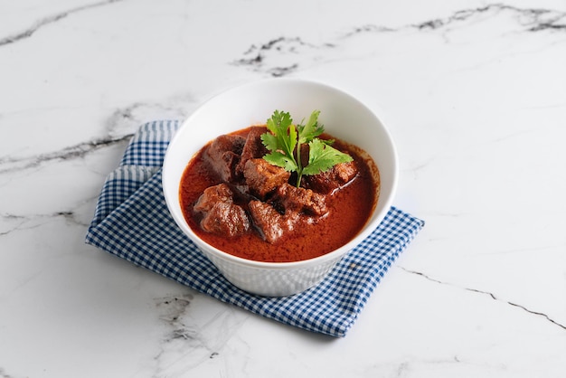 Mutton Rogan Josh mutten qorma mutten curry mutton karahi in a dish side view on grey background