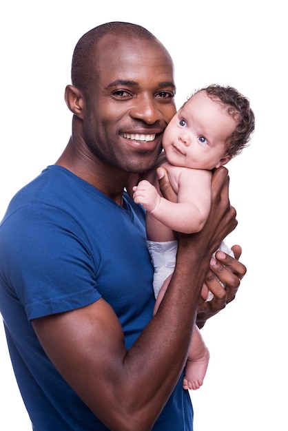 My baby! Happy young African man holding his little baby and smiling while standing isolated on white