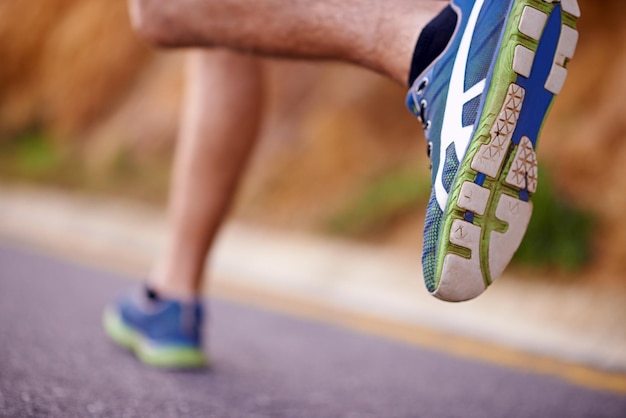 My favorite mode of transport Low angle shot of a mans legs running along a road