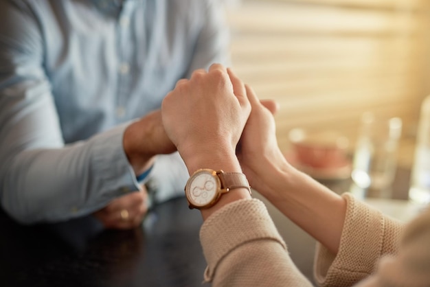 My hand in yours forever Shot of an affectionate young couple holding hands while sitting in a cafe