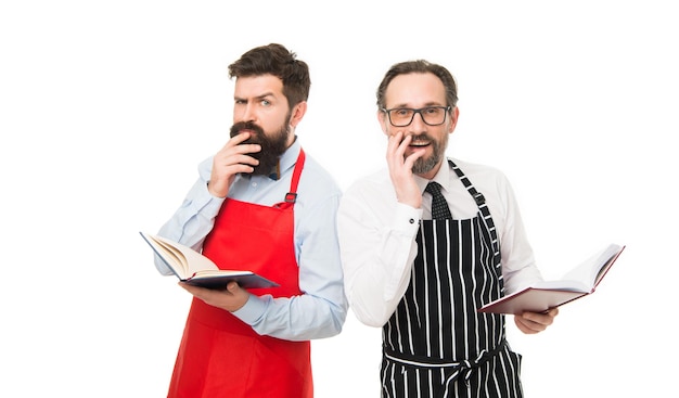 My job puzzled bearded men with recipe book catering business seating plan partners cook cooking Culinary ingredient menu planning happy chef team in apron cafe and restaurant opening