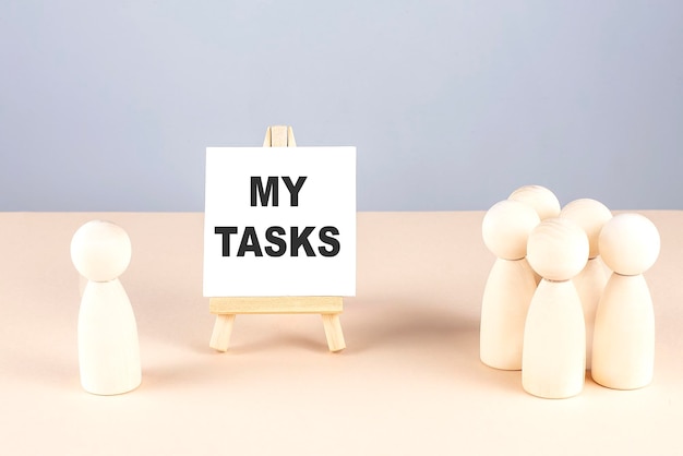 MY TASKS text on easel with wooden figure meeting concept