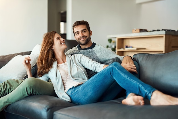 My weekend has officially kicked off Full length shot of an affectionate young couple relaxing on their sofa at home