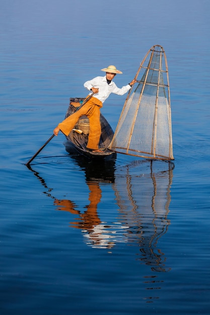 Myanmar travel attraction landmark Traditional Burmese fisherman at Inle lake Myanmar famous for their distinctive one legged rowing style