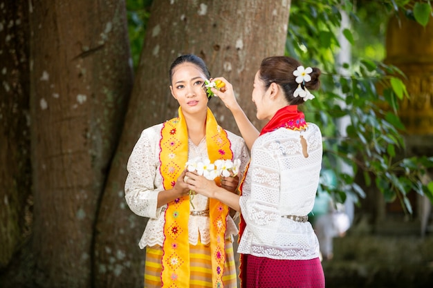 Myanmar women holding flowers at a temple Southeast Asian young girls with traditional dress