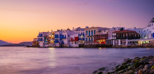 Mykonos Greece View of a traditional house in Mykonos The area of Little Venice Seascape during sunset Sea shore and beach Photo for travel and vacation