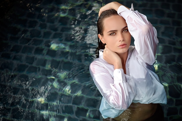 Mysterious girl with wet hair and white shirt