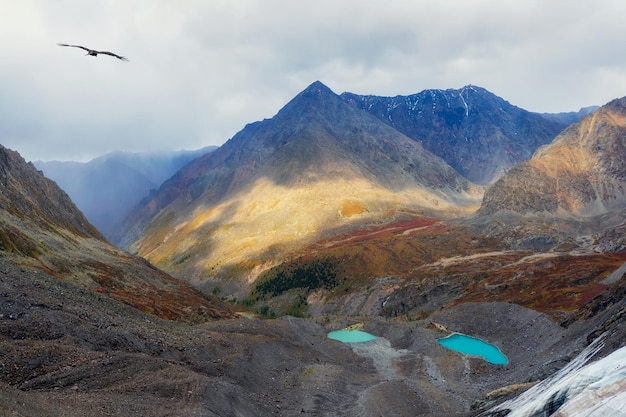 Mystical mountain valley with a glacier Beautiful Mountain landscape foggy windy mountain range Amazing Landscape mountain with cloudy sky on sunset Sunlight heaven scenery