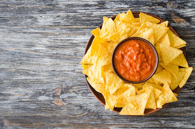 Nachos corn chips with spicy tomato sauce.