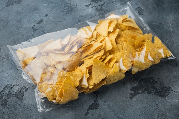 Nachos, triangle traditional Mexican corn appetizer pack, on gray table