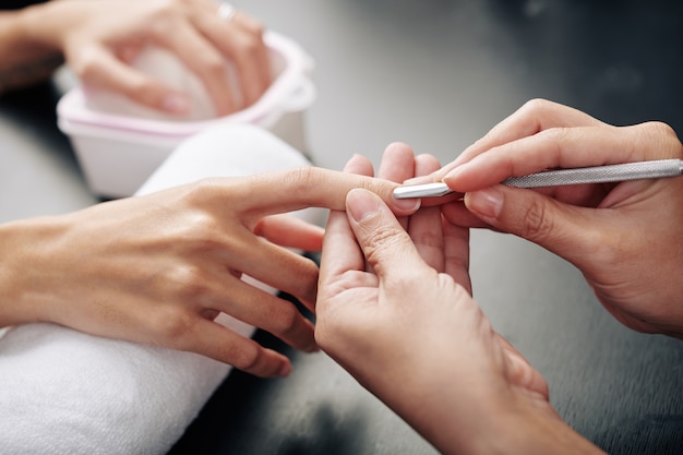 Nail master pushing cuticle