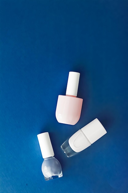 Nail polish bottles on dark blue background beauty brand