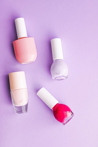 Nail polish bottles on purple background beauty brand