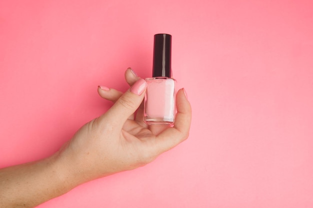 Nail polish in a woman's hand copy space Article about manicure Gel polish Hand care