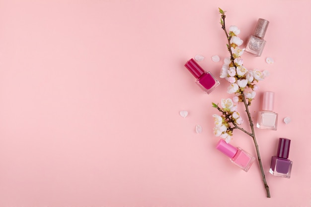 Nail polishes on a pink background