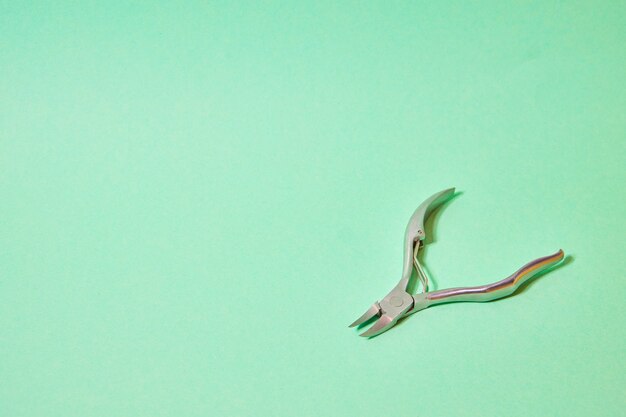 Nail tongs on a green background