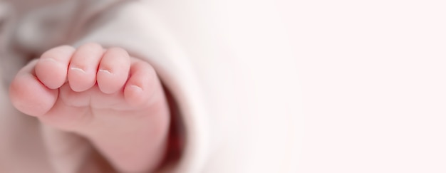 Naked caucasian newborn foot closeup copy space