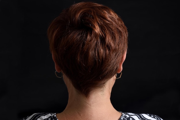 Nape of middle aged woman on black background